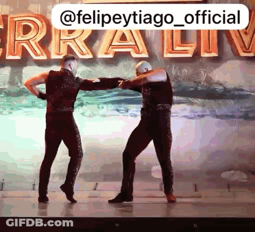 Two Men Dancing On Stage Ferra Live GIF