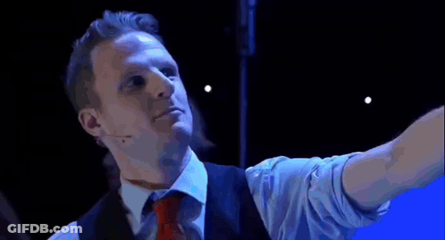 Two Men Dancing On Stage In Front Of Allow Screen GIF