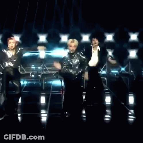 Two Men Dancing On Stage In Front Of Microphone GIF