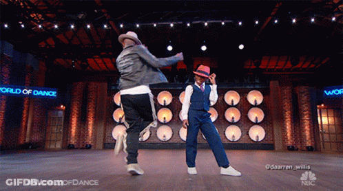 Two Men Dancing On Stage With World Of Dance Sign GIF