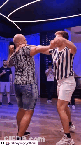 Two Men Dancing Together On Dance Floor GIF