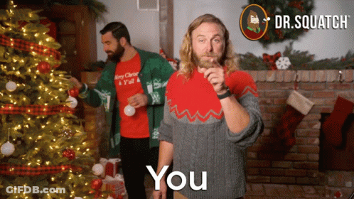 Two Men Decorating Christmas Tree One Wearing Merry Christmas Shirt GIF