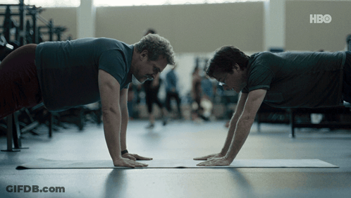 Two Men Do Push Ups On A Yoga Mat With Hbo Written On The Bottom Right GIF