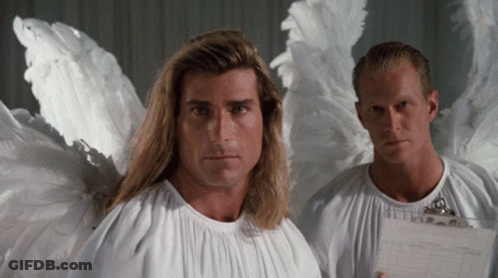 Two Men Dressed As Angels Are Standing Next To Each Other And One Is Holding A Clipboard GIF