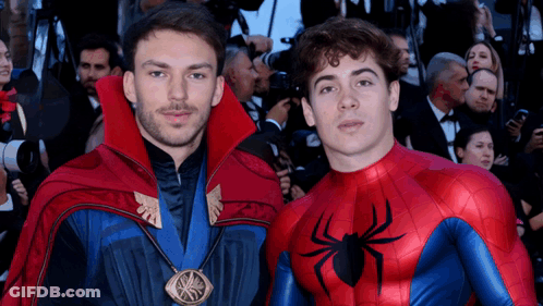 Two Men Dressed As Doctor Strange And Spider-Man Pose For A Picture GIF