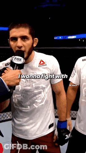 Two Men Drinking From Bottles In Front Of Phas Wall GIF