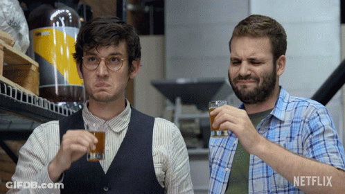 Two Men Drinking With Netflix Logo Behind GIF