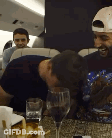 Two Men Drinking Wine And Laughing GIF