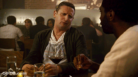 Two Men Drinking Wine And Talking At Table GIF