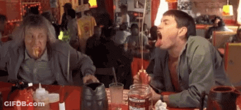 Two Men Eating Food With Ketchup GIF