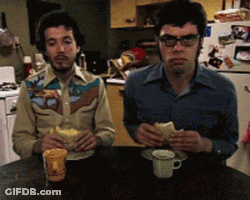 Two Men Eating One Wearing Cowboy Shirt GIF