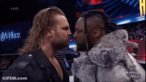 Two Men Facing Each Other In Front Of Live Sign GIF