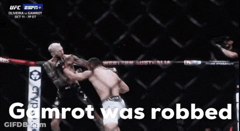 Two Men Fighting In A Cage With The Words Gamrot Was Robbed GIF