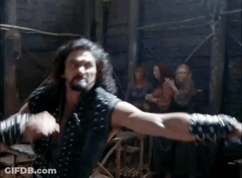 Two Men Fighting In A Room With Spectators GIF
