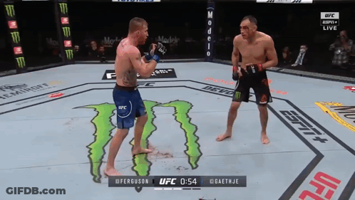 Two Men Fighting In A Ufc Ring With A Monster On The Ground GIF