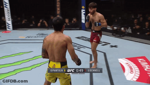Two Men Fighting In Boxing Ring At 0:49 GIF