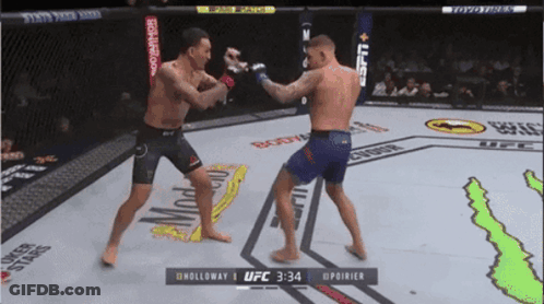 Two Men Fighting In Boxing Ring At 2:34 GIF