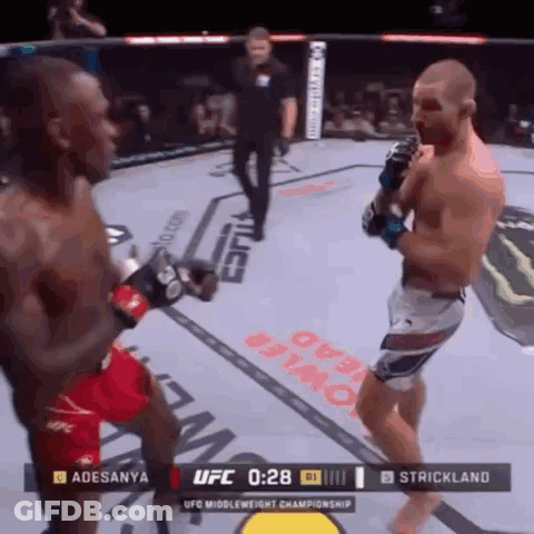 Two Men Fighting In Boxing Ring GIF
