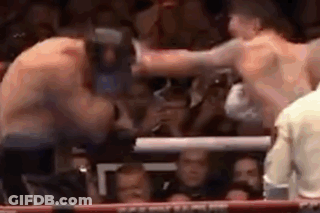 Two Men Fighting In Boxing Ring In Front Of Crowd GIF