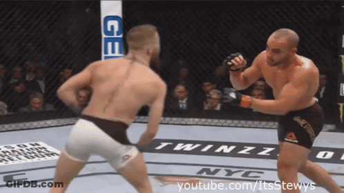 Two Men Fighting In Boxing Ring GIF