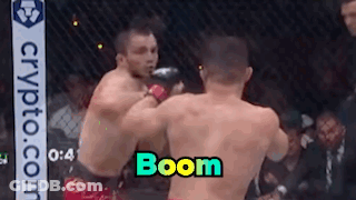 Two Men Fighting In Boxing Ring Saying Boom GIF