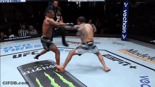 Two Men Fighting In Boxing Ring Sponsored By OYO Tires And Modelo GIF