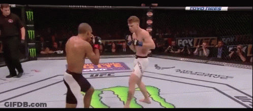 Two Men Fighting In Boxing Ring Sponsored By Toyo Tires And Monster GIF