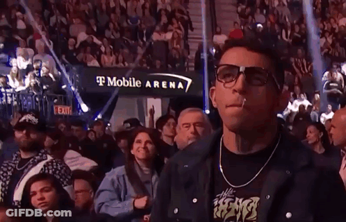 Two Men Fighting In Boxing Ring With Crowd Watching GIF