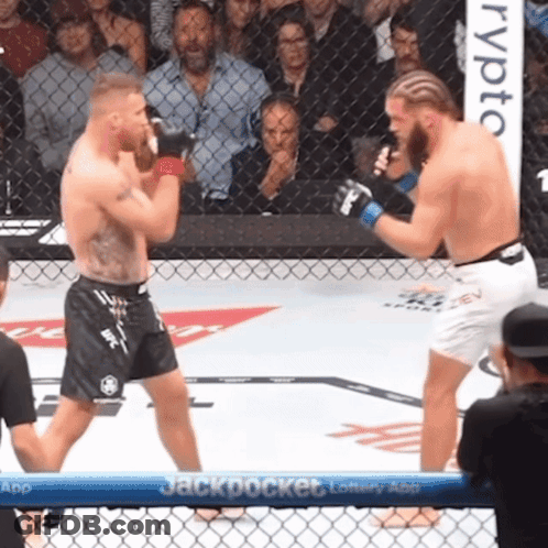 Two Men Fighting In Boxing Ring With Jackpot Banner GIF