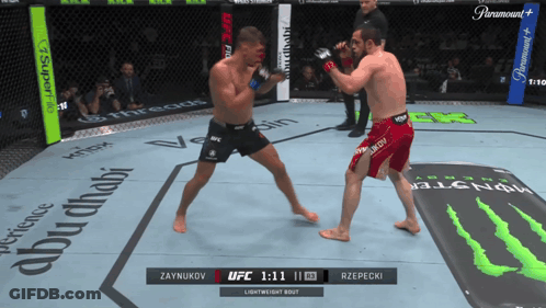 Two Men Fighting In Boxing Ring With Monster Energy Mat GIF
