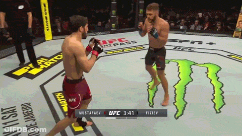 Two Men Fighting In Boxing Ring With Monster On Floor GIF