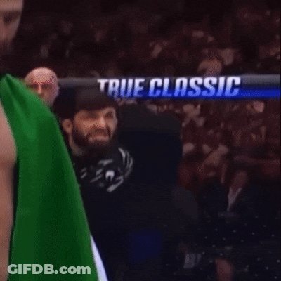 Two Men Fighting In Boxing Ring With No Holds Barred Shorts GIF