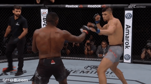 Two Men Fighting In Boxing Ring With Reebok And Amarak Banners GIF