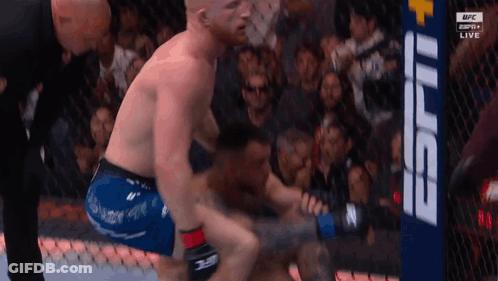 Two Men Fighting In Boxing Ring With Referee GIF