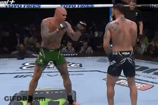 Two Men Fighting In Boxing Ring With Referee Watching GIF