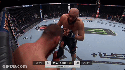Two Men Fighting In Boxing Ring With Scoreboard Saying Significant Strikes GIF
