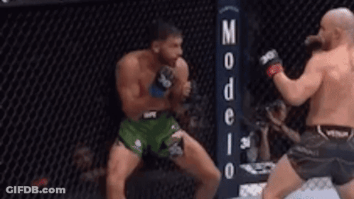 Two Men Fighting In Boxing Ring With Sign GIF