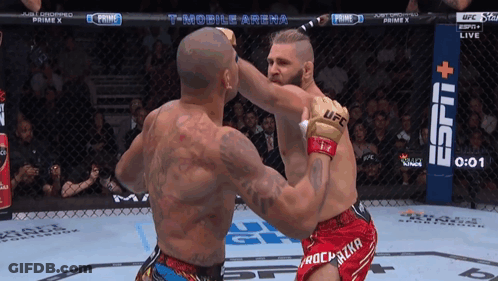 Two Men Fighting In Boxing Ring With T-Mobile Arena Banner GIF