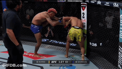 Two Men Fighting In Boxing Ring With UFC 1:27 Display GIF