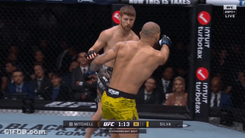 Two Men Fighting In Boxing Ring With Venum Belt GIF
