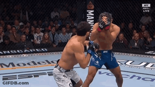 Two Men Fighting In Cage Before Crowd GIF