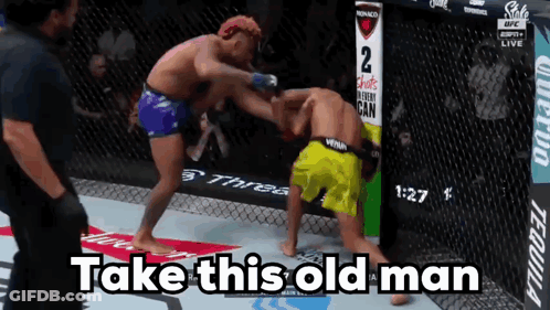 Two Men Fighting In Cage Saying Take This Old Man GIF