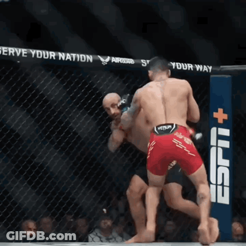 Two Men Fighting In Cage With ESPN Sign GIF