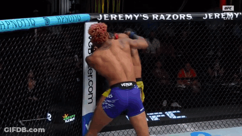 Two Men Fighting In Cage With Jeremy's Razors GIF