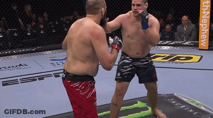 Two Men Fighting In Cage With Monster Energy Ad GIF