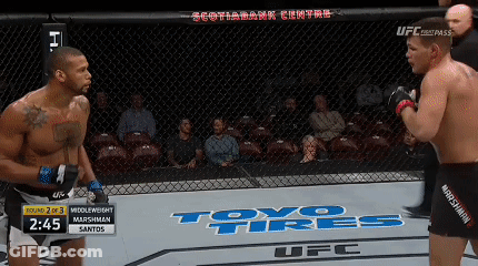 Two Men Fighting In Cage With Toyo Tires On Floor GIF