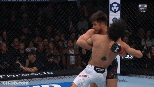 Two Men Fighting In Cage With Venum Tattoo GIF