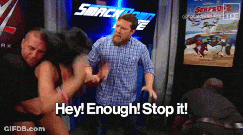 Two Men Fighting In Front Of Smackdown Sign GIF