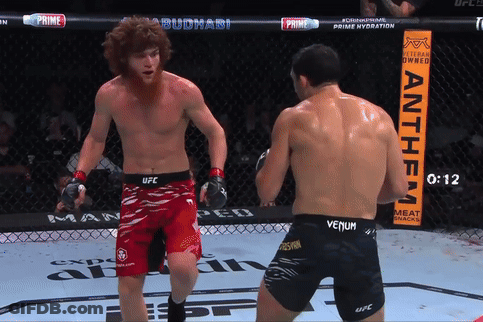 Two Men Fighting In Ring With Anthem Sign GIF