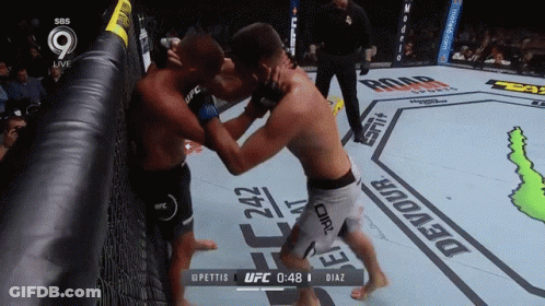Two Men Fighting In UFC Ring With Devour GIF